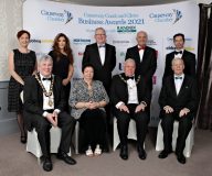 At the Presidents Tables for the Causeway Chamber of Commerce Awards 2021, seated l-r Cllr Richard Holmes Mayor Causeway Coast & Glens Borough Council,  Dawn McLaughlin  President Londonderry Chamber of Commerce, David Boyd President of Causeway Chamber of Commerce, Mr Gregory Campbell MP,standing, Anne Marie McGoldrick, Chamber Vice President and director of The Electric Storage Company, Cara Hunter MLA, Eddie McGoldrick The Electric Storage Company, Wavell Moore Zomba Action Project with Mel Higgins  Northern Regional College, Acting Principal.02 Chamber Awards 2021