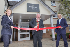 Causeway Coast and Glens Council Mayor Cllr Ivor Wallace has the honour of cutting the ribbon at the official opening of the Riverside Hotel Coleraine pictured with Karen Yates CEO Causeway Chamber of Commerce along with Rajesh Rana Director of the Andras House Hotel Group. 05 Riverside Hotel Coleraine